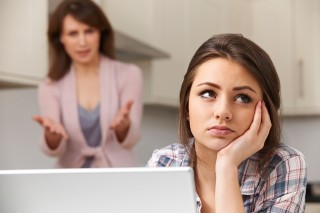 Mother Arguing With Teenage Daughter Over Online Activity
